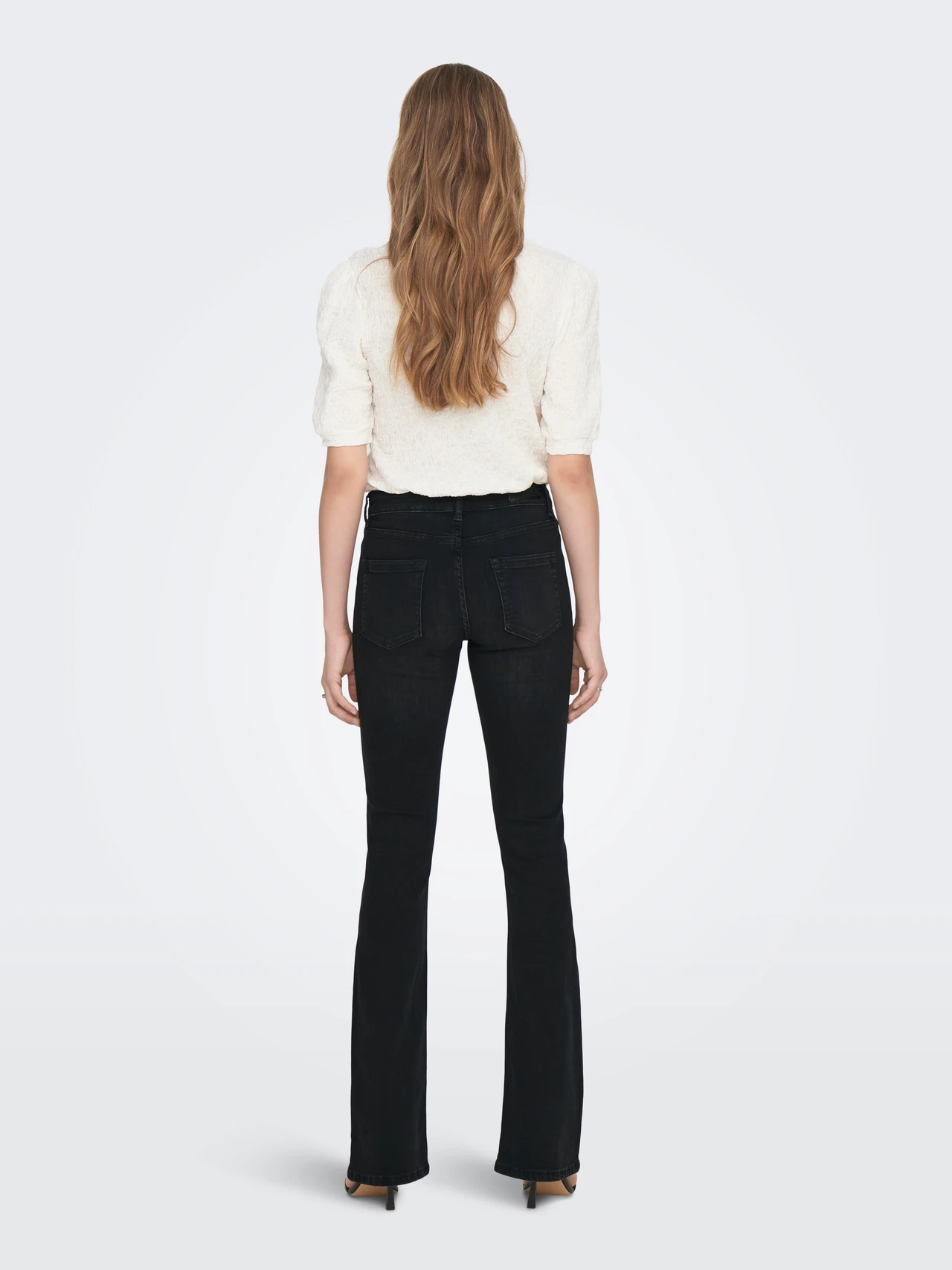 Only women black mid flare denim jeans with flattering fit, authentic leftover stock at Telo.pk