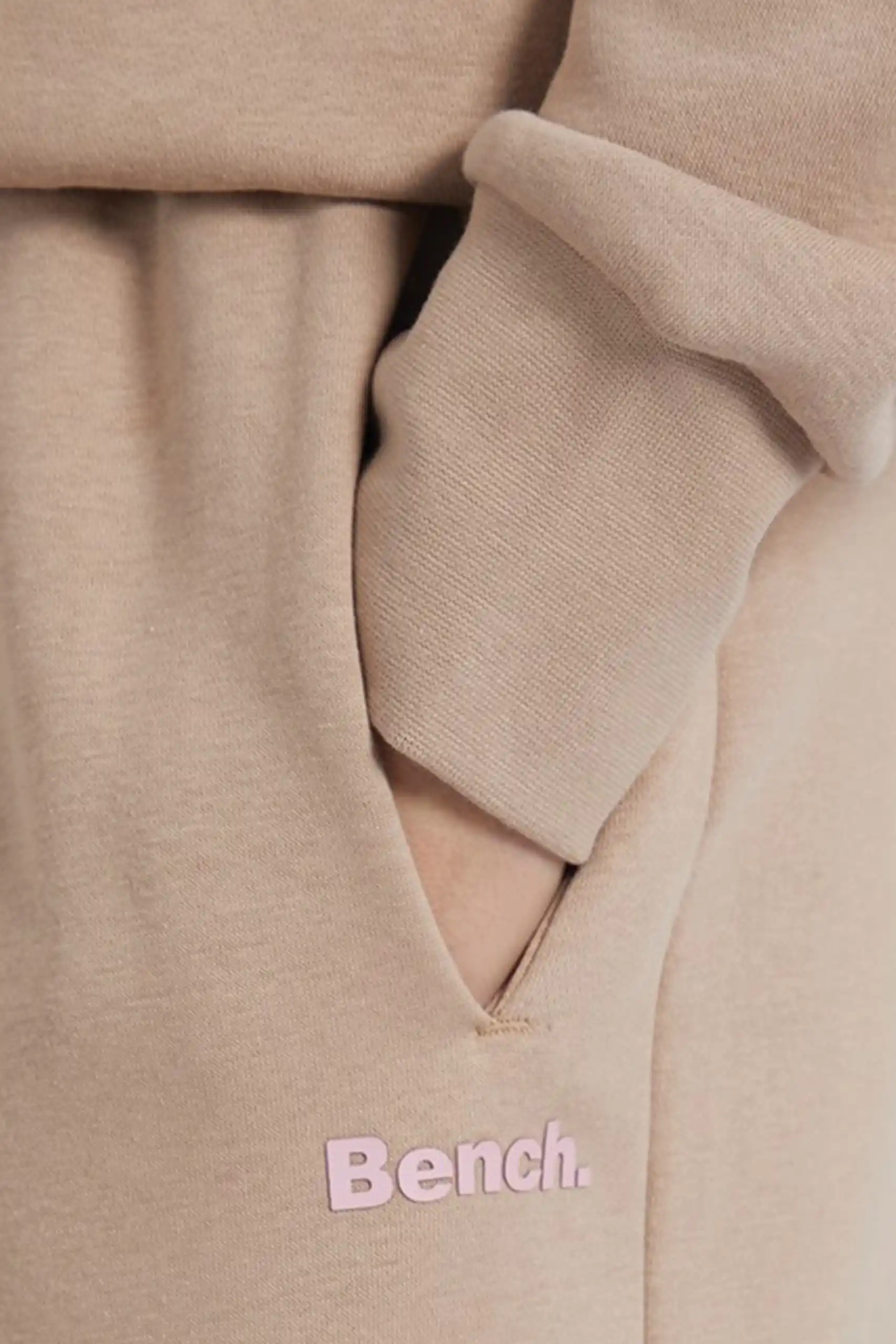 Women wearing cotton blend tracksuit with hoodie and wide leg joggers in loose shoulder casual style