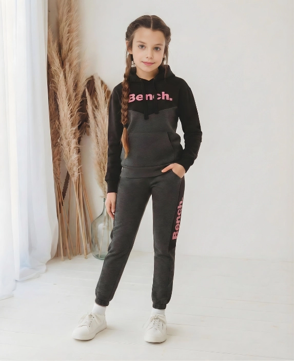Kids wearing cotton blend tracksuit with hoodie and wide leg joggers in loose shoulder casual style